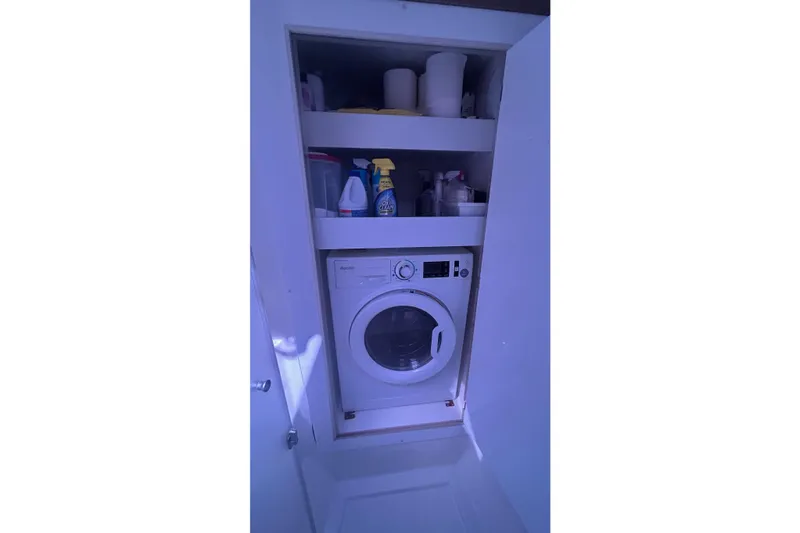 Slide: The Image of Laundry area on 2019 Fountaine Pajot Helia 44 Evolution yacht with washer and cleaning supplies. - 54