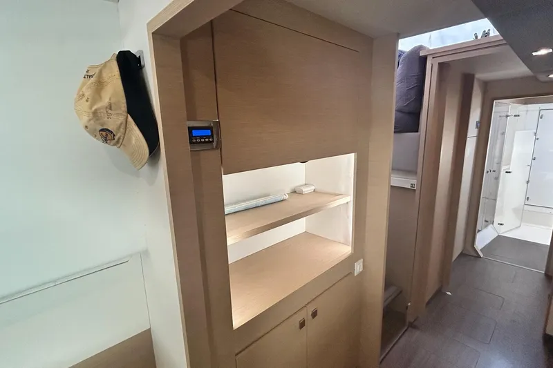 Slide: The Image of Interior of 2019 Fountaine Pajot Helia 44 Evolution catamaran, featuring wooden cabinetry and hallway. - 58