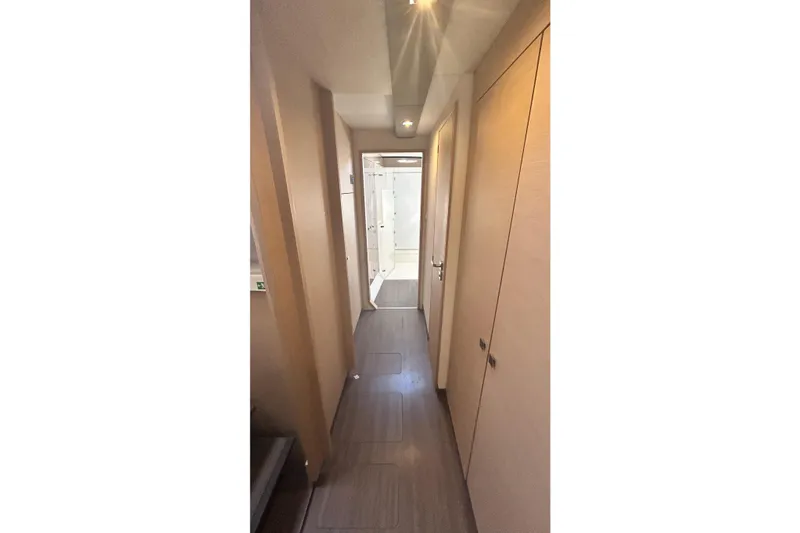 Slide: The Image of Narrow hallway inside 2019 Fountaine Pajot Helia 44 Evolution catamaran, featuring modern wood paneling. - 59
