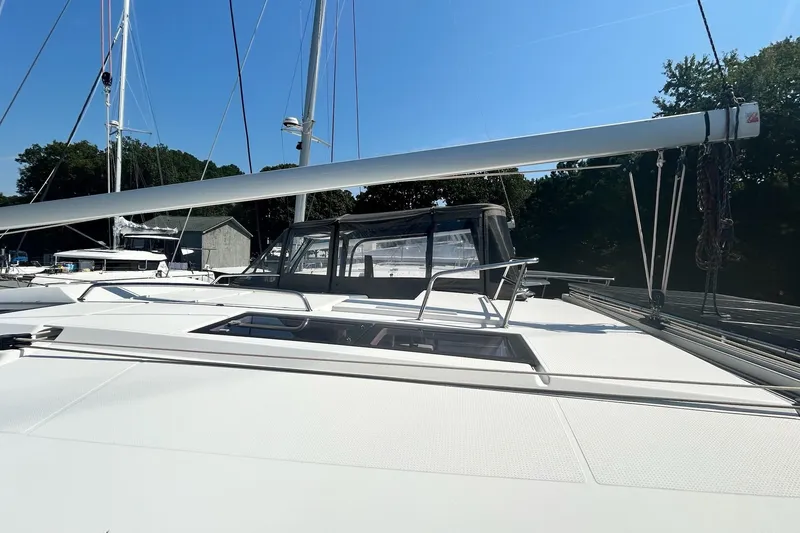 Slide: The Image of 2019 Fountaine Pajot Helia 44 Evolution catamaran, docked with clear sky background. - 6