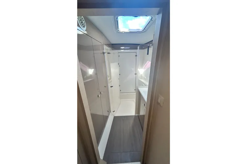 Slide: The Image of Bathroom interior of 2019 Fountaine Pajot Helia 44 Evolution catamaran, featuring modern design and skylight. - 60