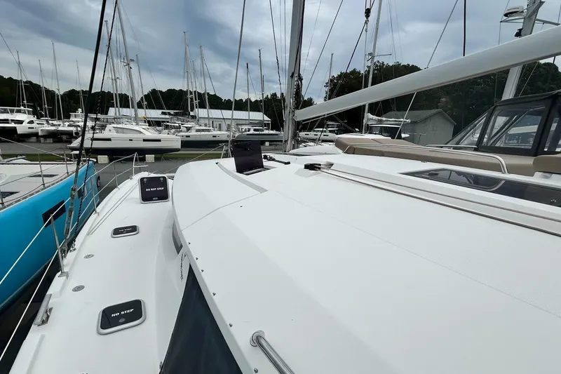 Slide: The Image of 2019 Fountaine Pajot Helia 44 Evolution catamaran docked at marina, showcasing sleek design. - 8