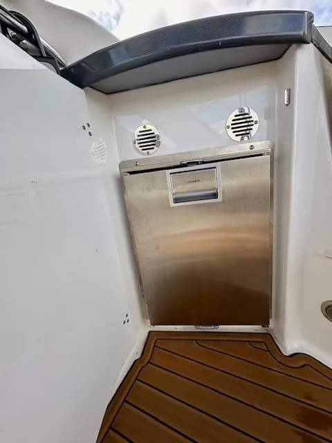 Slide: The Image of 2006 Doral Elegante boat interior with stainless steel appliance and wood flooring. - 16