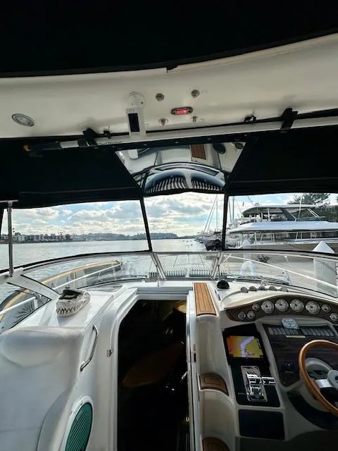 Slide: The Image of 2006 Doral Elegante yacht cockpit with navigation instruments, steering wheel, and waterfront view. - 17