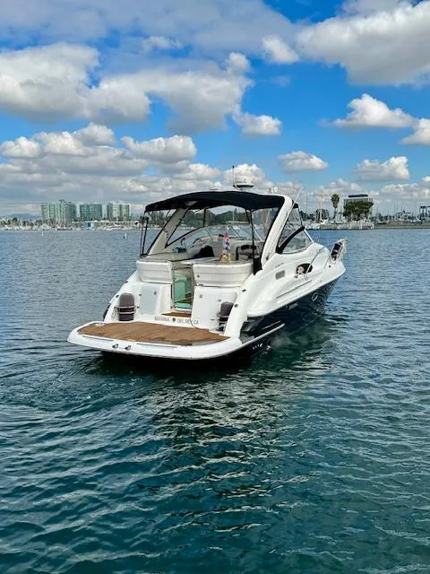 Slide: The Image of 2006 Doral Elegante boat on calm water under a partly cloudy sky. - 2