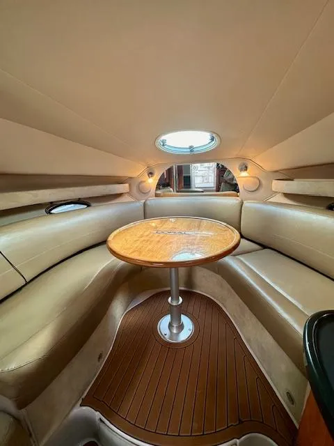 Slide: The Image of 2006 Doral Elegante boat interior with round table and leather seating. - 20