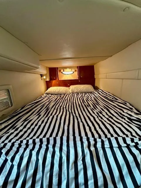 Slide: The Image of 2006 Doral Elegante cabin interior with striped bedding and cozy sleeping area. - 23