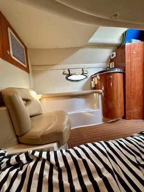 Slide: The Image of Interior of a 2006 Doral Elegante boat with seating and wooden cabinetry. - 24