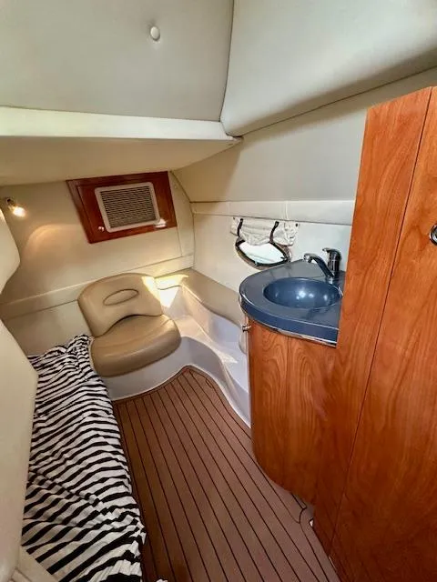 Slide: The Image of 2006 Doral Elegante cabin interior with wood accents, sink, and seating area. - 25