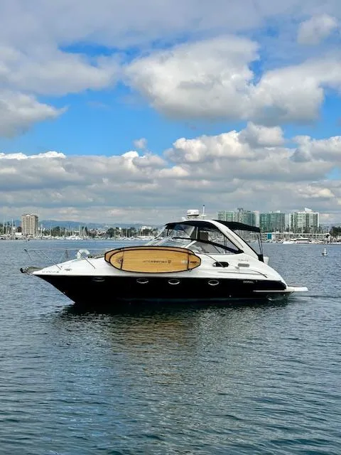 Slide: The Image of 2006 Doral Elegante yacht cruising on a calm, scenic waterfront. - 26