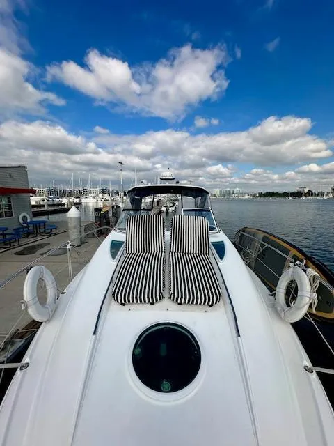 Slide: The Image of 2006 Doral Elegante yacht with striped sun loungers, docked under a blue sky. - 29