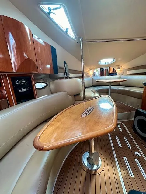 Slide: The Image of 2006 Doral Elegante yacht interior with wooden table, leather seating, and modern amenities. - 33