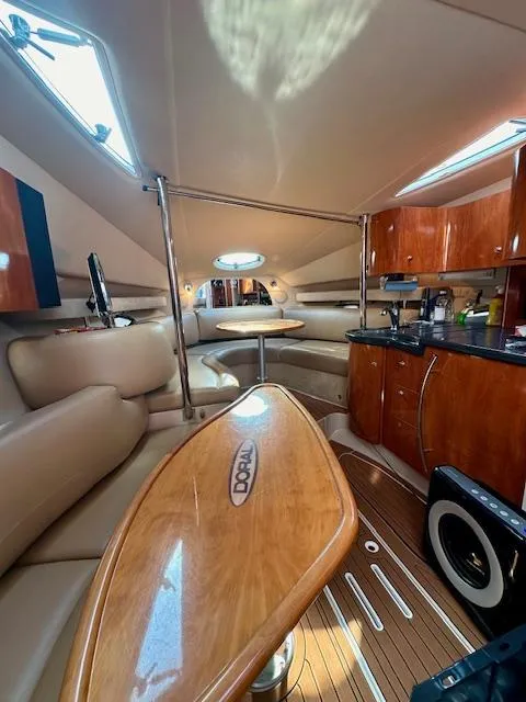 Slide: The Image of Interior of a 2006 Doral Elegante yacht with luxurious seating and wooden finishes. - 34