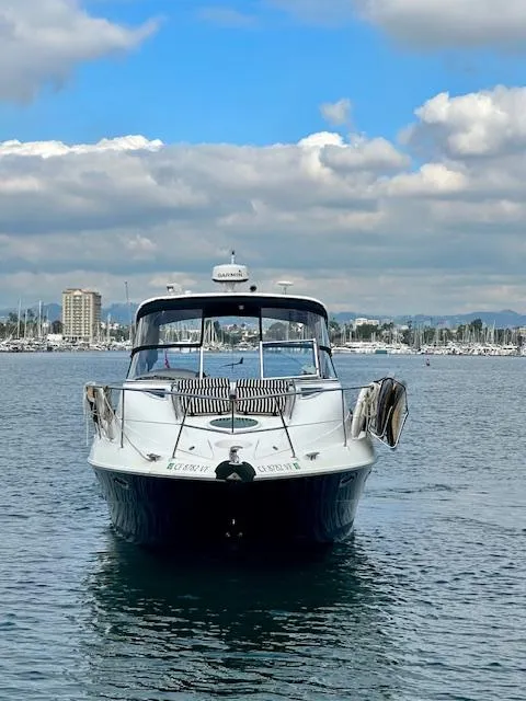 Slide: The Image of 2006 Doral Elegante boat on calm water under a partly cloudy sky. - 5