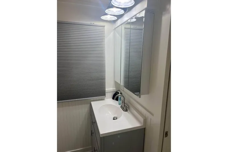 Slide: The Image of Bathroom vanity with mirror and sink in 1999 Sharpe houseboat. - 10