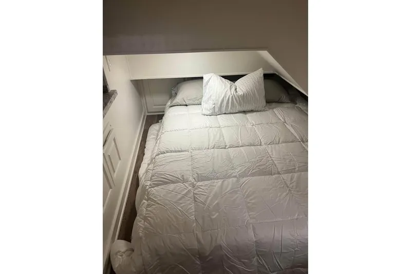 Slide: The Image of Cozy bedroom in 1999 Sharpe houseboat with white bedding and pillows. - 15