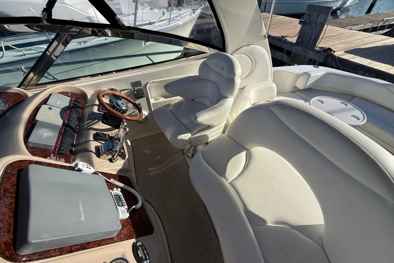 Slide: The Image of 2004 Sea Ray 380 Sundancer helm with leather seating and modern controls. - 12