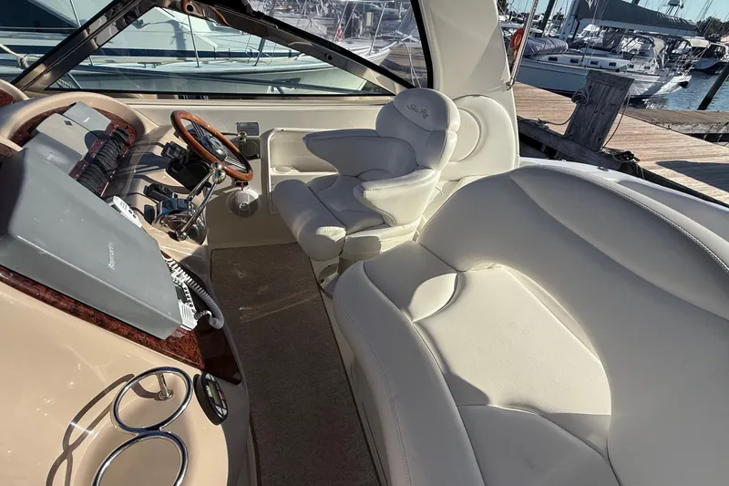 Slide: The Image of 2004 Sea Ray 380 Sundancer cockpit with leather seating and steering wheel, docked at marina. - 13