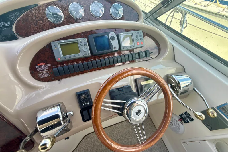 Slide: The Image of Helm of 2004 Sea Ray 380 Sundancer with wooden steering wheel and navigation instruments. - 15