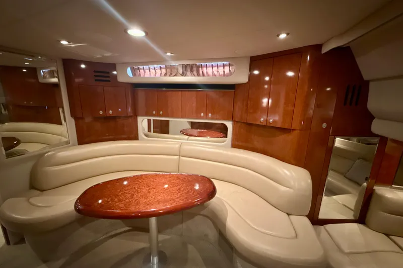Slide: The Image of Luxurious interior of 2004 Sea Ray 380 Sundancer with elegant seating and wooden cabinetry. - 25