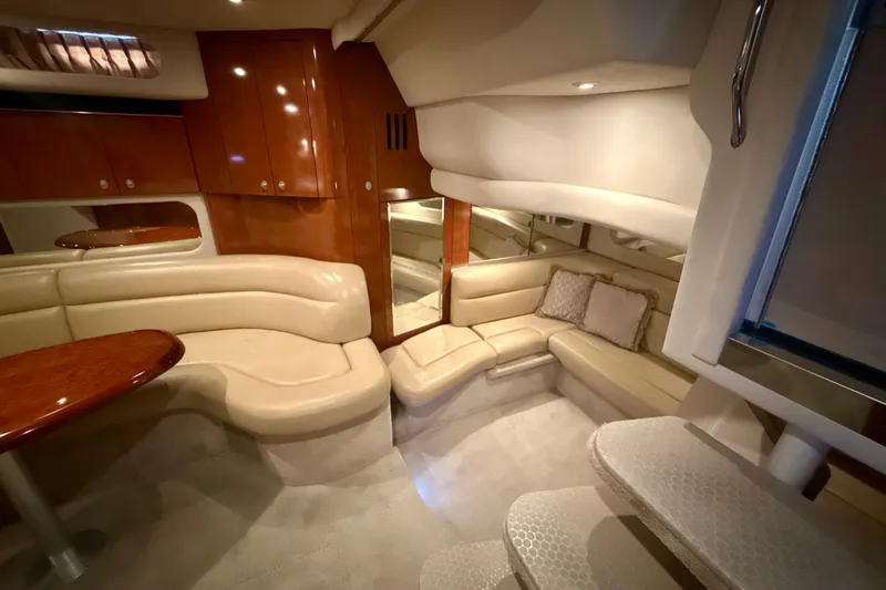 Slide: The Image of Luxurious interior of 2004 Sea Ray 380 Sundancer yacht with plush seating and wooden cabinetry. - 26