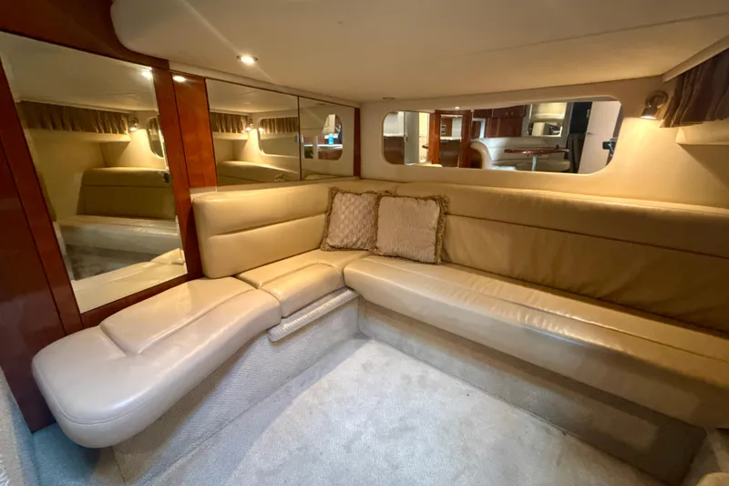 Slide: The Image of Luxurious interior of 2004 Sea Ray 380 Sundancer with beige leather seating and mirrors. - 27
