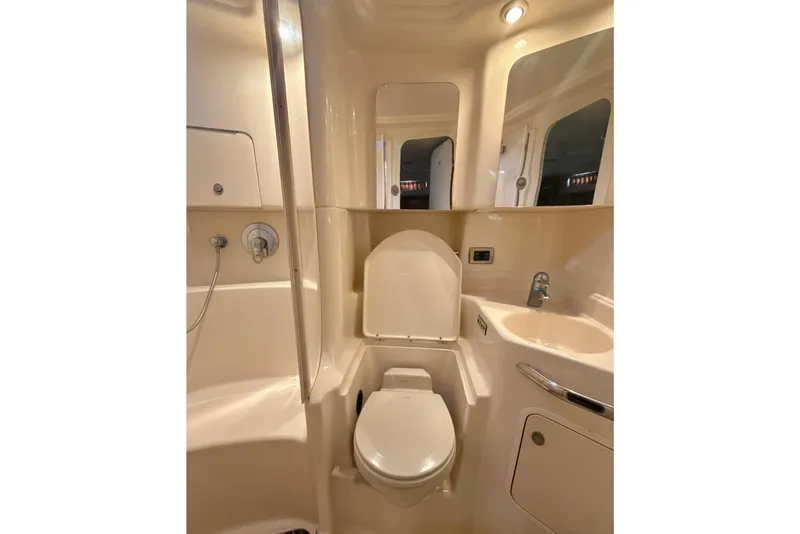 Slide: The Image of 2004 Sea Ray 380 Sundancer bathroom with shower, toilet, and sink. - 36