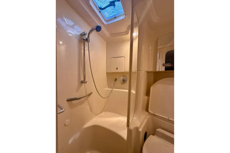 Slide: The Image of 2004 Sea Ray 380 Sundancer bathroom with shower, skylight, and modern fixtures. - 38