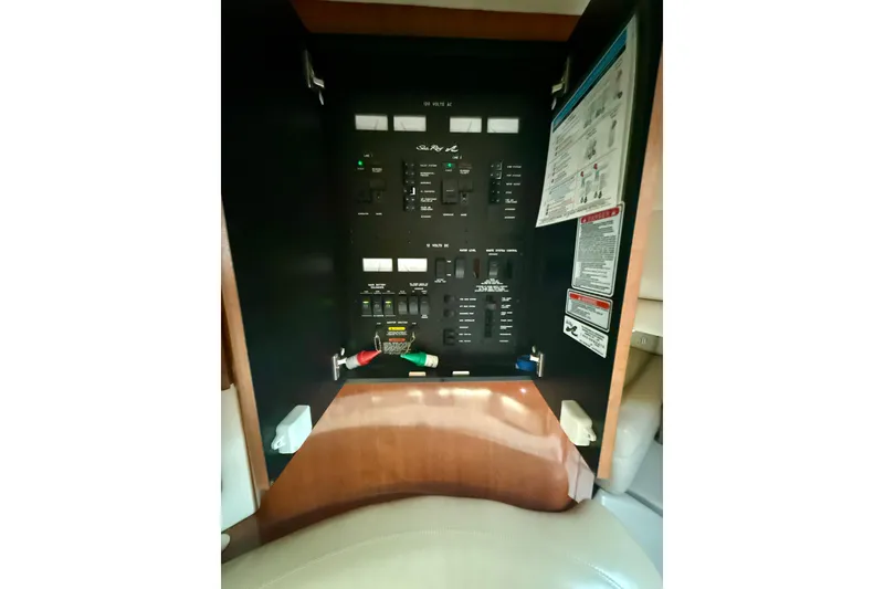 Slide: The Image of Electrical panel of 2004 Sea Ray 380 Sundancer boat, featuring various switches and controls. - 39