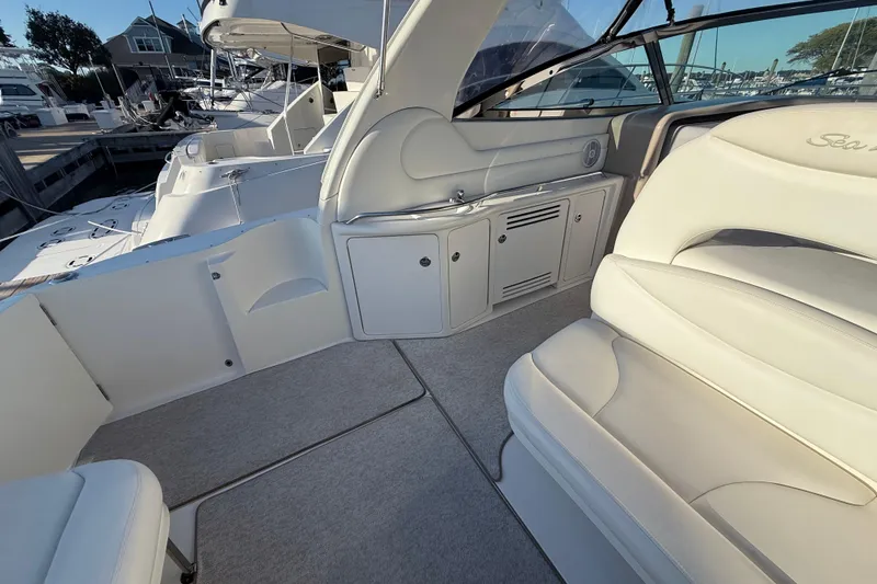 Slide: The Image of Interior of 2004 Sea Ray 380 Sundancer yacht with white seating and cabinetry. - 9