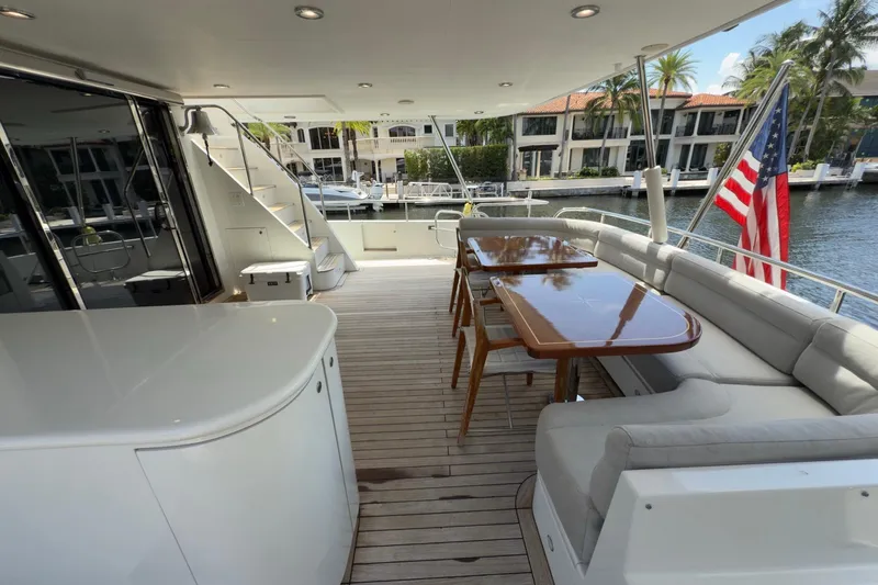 Slide: The Image of 2006 Cheoy Lee 84 Bravo yacht "Family Time" with jet ski, cruising on a scenic waterway. - 12