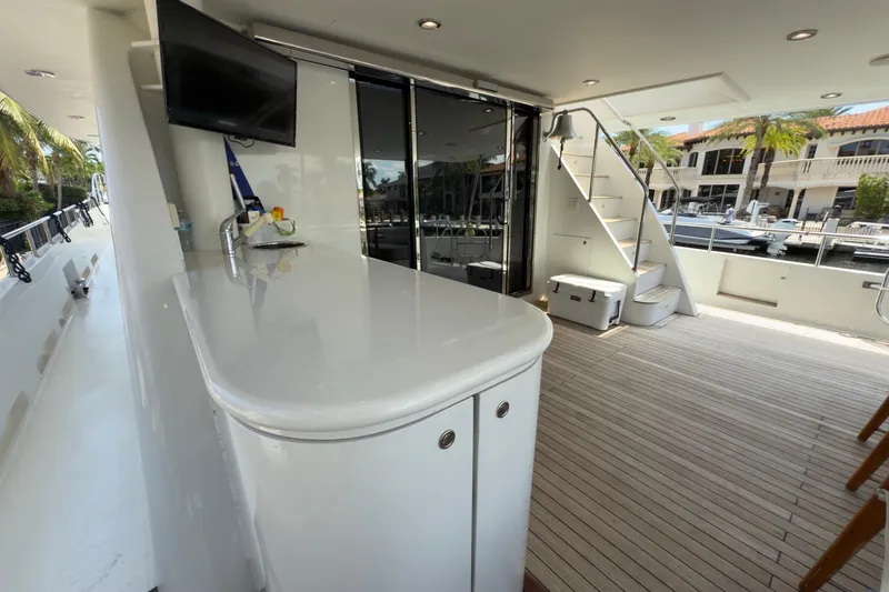 Slide: The Image of Luxury 2006 Cheoy Lee 84 Bravo yacht cruising on a scenic waterway. - 13
