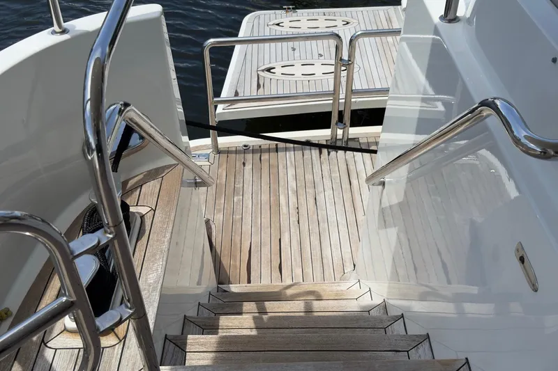 Slide: The Image of Luxury 2006 Cheoy Lee 84 Bravo yacht with sun loungers on deck, cruising a scenic waterway. - 18