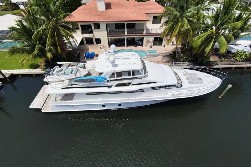 Slide: The Image of Front view of 2006 Cheoy Lee 84 Bravo yacht on water, with city skyline backdrop. - 2