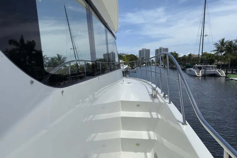Slide: The Image of Luxurious 2006 Cheoy Lee 84 Bravo yacht deck with seating and jacuzzi under blue sky. - 27