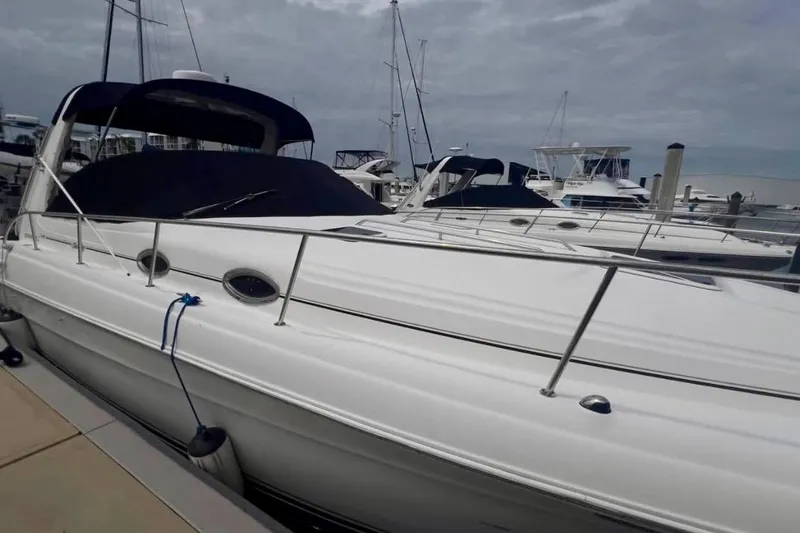 Slide: The Image of 2000 Sea Ray 340 Sundancer docked at marina under cloudy sky. - 6