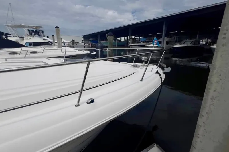 Slide: The Image of 2000 Sea Ray 340 Sundancer docked at marina, surrounded by other boats. - 7