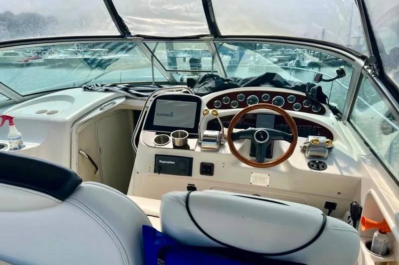 Slide: The Image of Cockpit of 2000 Sea Ray 340 Sundancer with steering wheel and navigation equipment. - 8