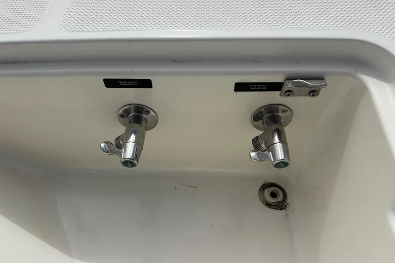 Slide: The Image of Water faucets on a 2004 Meridian 580 Pilothouse boat, labeled for fresh and raw water. - 103