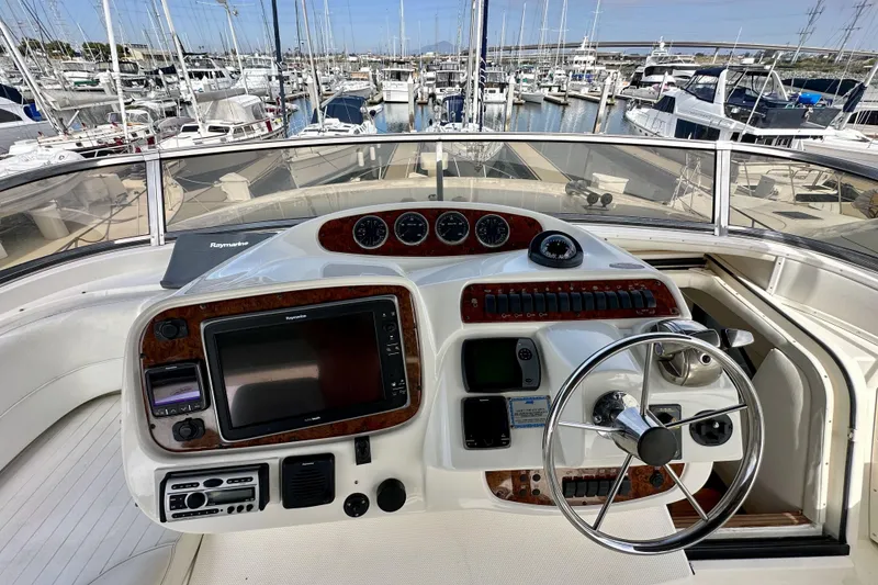 Slide: The Image of Pilothouse of 2004 Meridian 580 yacht with navigation controls, docked in marina. - 119