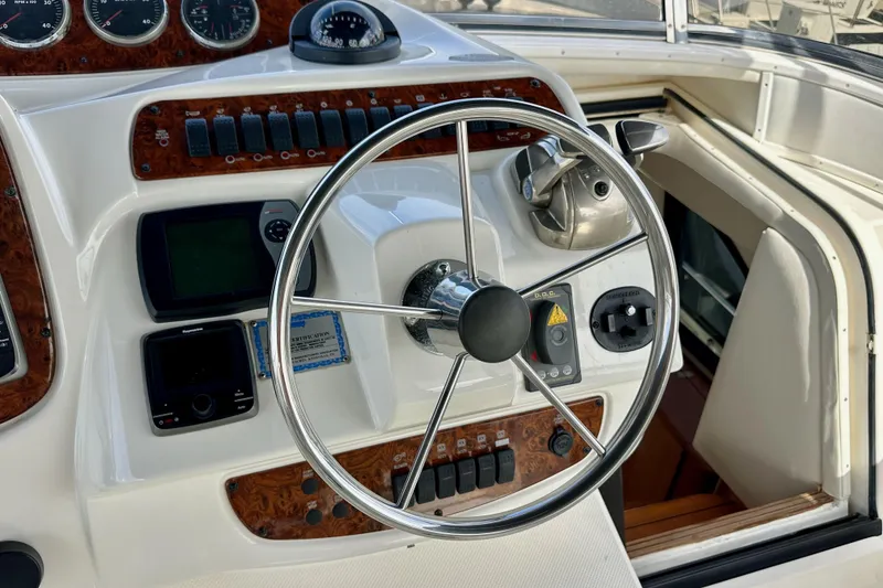 Slide: The Image of Steering wheel and controls of a 2004 Meridian 580 Pilothouse yacht. - 121
