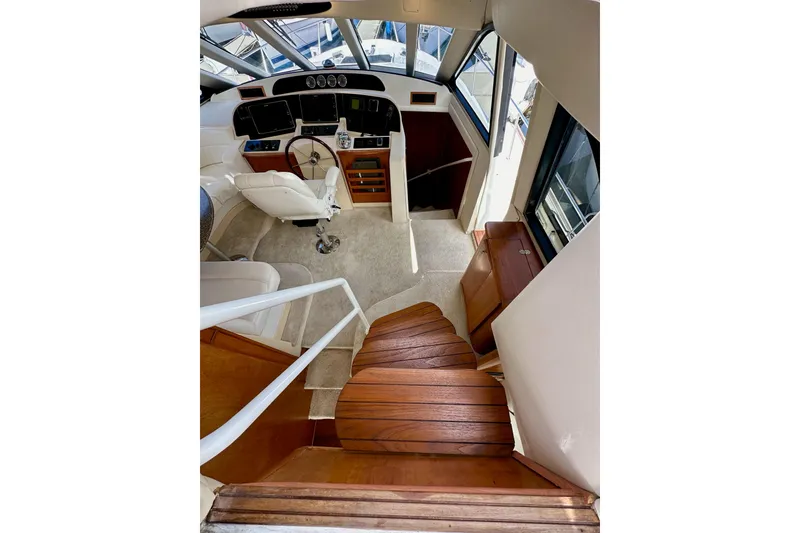 Slide: The Image of Interior view of 2004 Meridian 580 Pilothouse with wooden stairs and pilothouse controls. - 124
