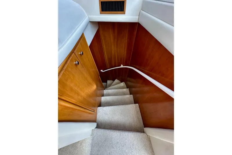 Slide: The Image of Staircase inside 2004 Meridian 580 Pilothouse yacht with wooden paneling and carpeted steps. - 126