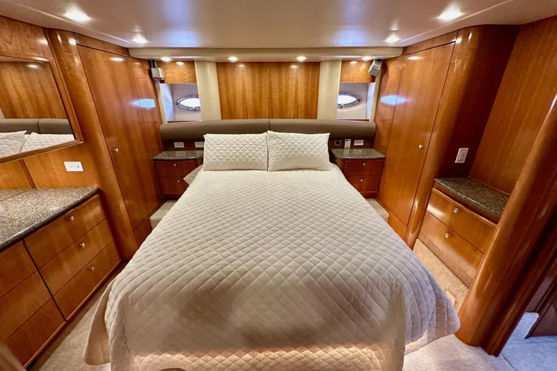Slide: The Image of Luxurious 2004 Meridian 580 Pilothouse bedroom with elegant wood cabinetry and cozy bedding. - 133