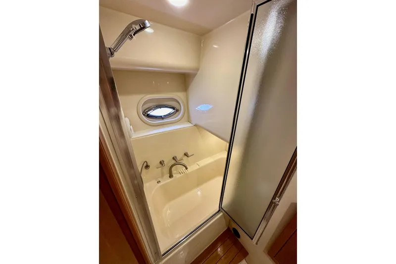 Slide: The Image of Luxurious bathroom in 2004 Meridian 580 Pilothouse yacht with shower and porthole window. - 137