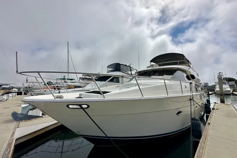 Slide: The Image of 2004 Meridian 580 Pilothouse yacht docked at marina under cloudy sky. - 14