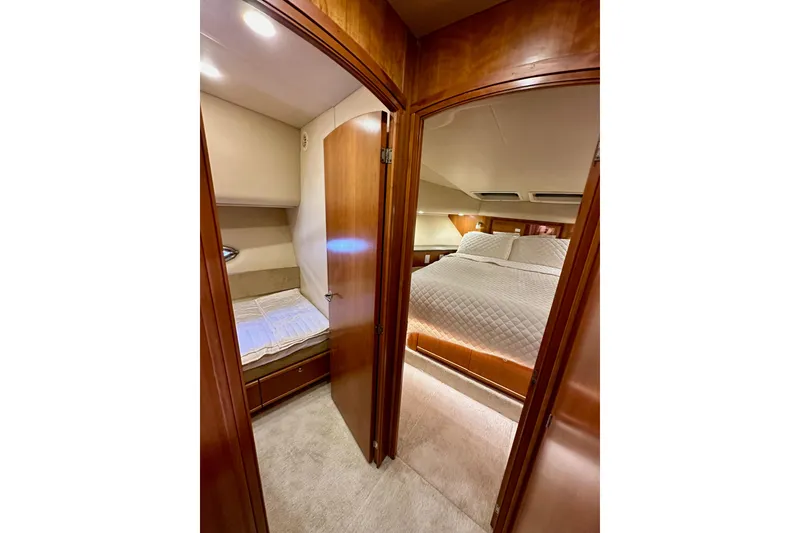 Slide: The Image of Interior of 2004 Meridian 580 Pilothouse showing two cozy bedrooms with wooden finishes. - 140
