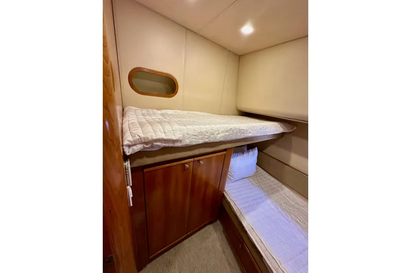 Slide: The Image of 2004 Meridian 580 Pilothouse cabin with bunk beds and wooden cabinetry. - 142