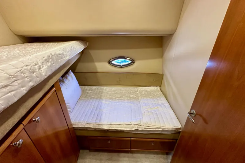 Slide: The Image of Cozy cabin interior of 2004 Meridian 580 Pilothouse with bunk beds and porthole window. - 143