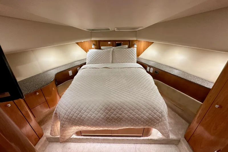 Slide: The Image of Luxurious bedroom in 2004 Meridian 580 Pilothouse yacht with elegant wood finishes. - 146
